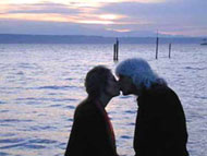 Andie and Greg kissing at sunset