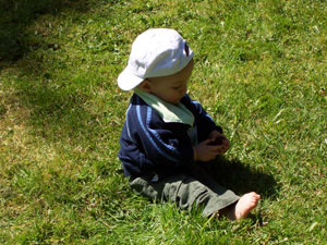 Kayden in the backyard with a cool baseball hat